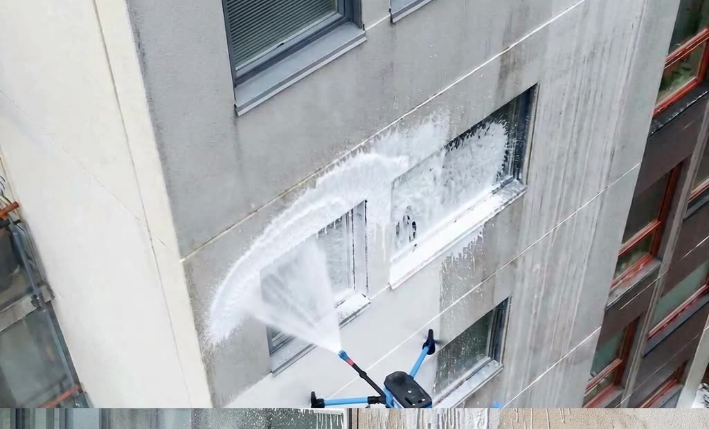 Drohne trägt Reinigungsschaum auf eine Putzfassade auf