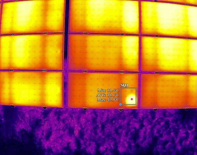 Wärmebild eines Modulfelds mit gesetztem Messfenster: Minimal-, Mittel- und Maximaltemperatur des auffälligen Bereichs werden beziffert.